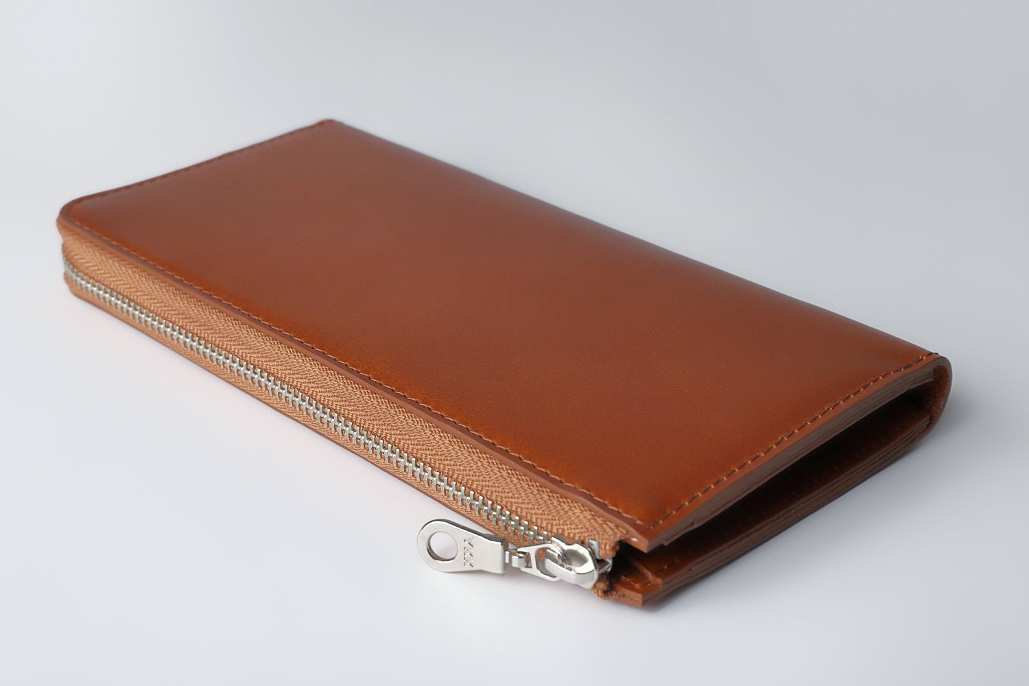 MC-longwallet。蔵前の革職人が製作した国産牛革のL字ファスナーコンパクト長財布。キャメル。斜めから側面のイメージ。