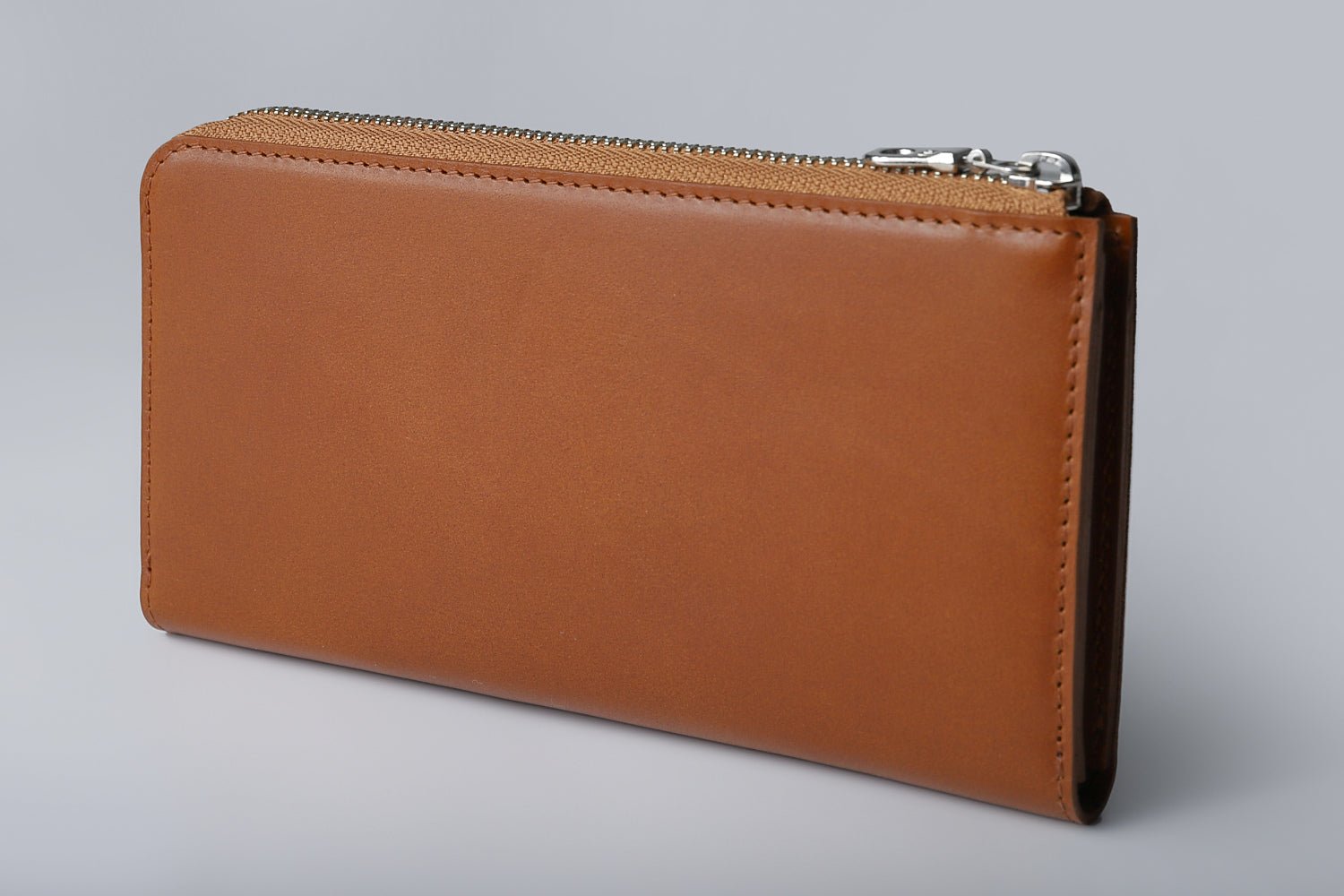 MC-longwallet。蔵前の革職人が製作した国産牛革のL字ファスナーコンパクト長財布。キャメル。斜めのイメージ。
